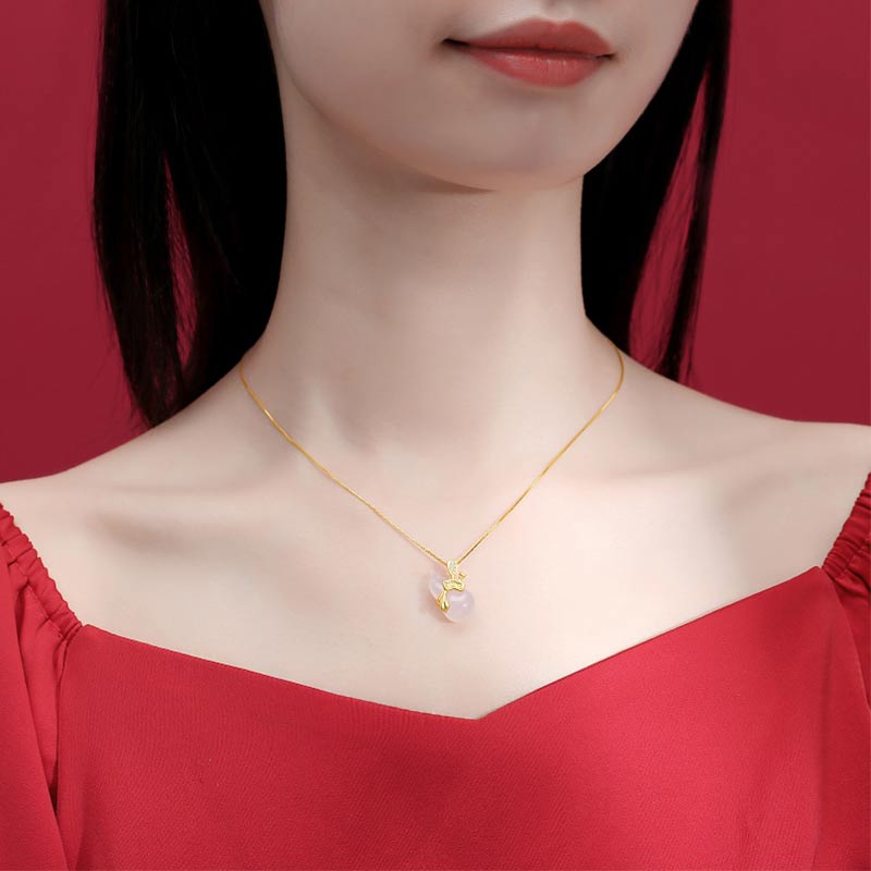 Cyan Jade Gourd Pendant Necklace - model wearing rose quartz gourd pendant with gold chain on red, lifestyle jewelry
