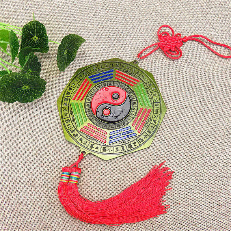 Feng Shui Bagua Map Mirror - Bagua mirror amulet with yin-yang symbol, colored trigrams, red tassel and decorative knot on n.