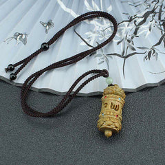 Om Mani Padme Hum Necklace – Sandalwood prayer wheel pendant on braided cord with jade bead, fan backdrop, zen jewelry