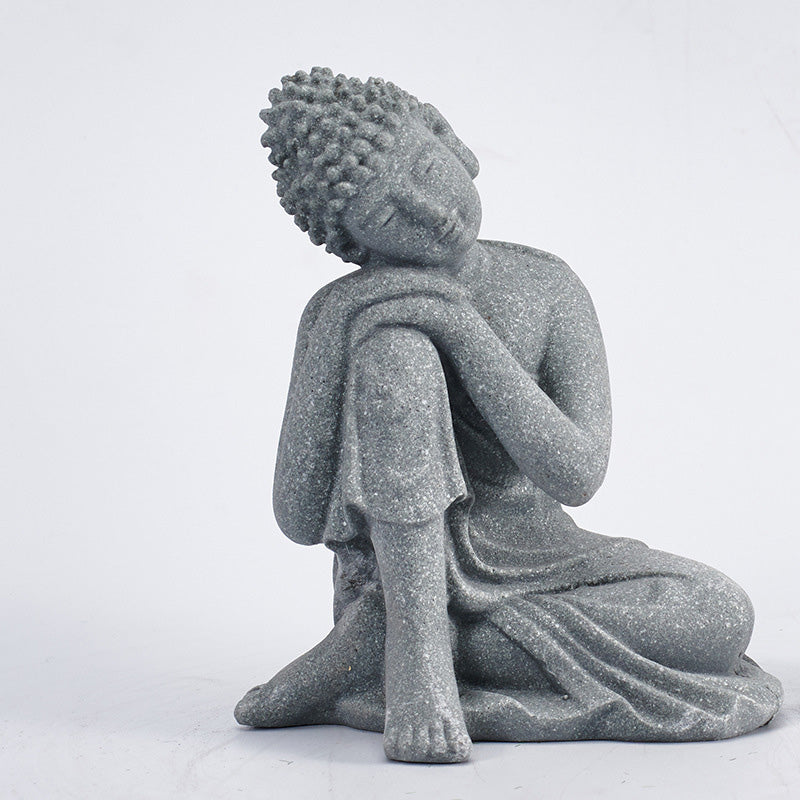Sitting Meditation Buddha Sandstone Statue – three-quarter resting, head on arms, contemplative