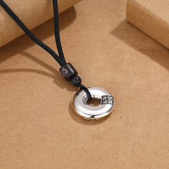 PiXiu Peace Buckle Copper Wealth Necklace – Back of silver peace buckle with Chinese characters on cord, talisman