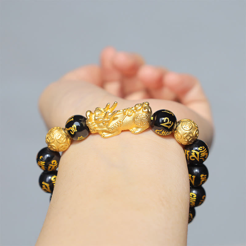 FengShui PiXiu Obsidian Bracelet – worn on wrist gray background gold PiXiu black beads, protection bracelet