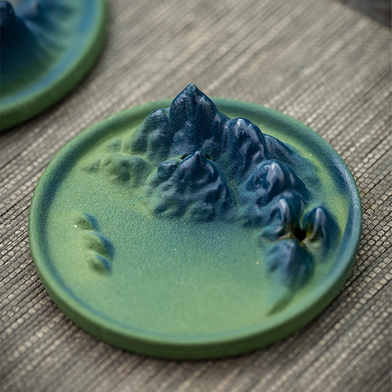 Ceramic Backflow Incense Burner – Sage-green mountain with incense stick on wood, soft lighting, minimalist zen