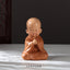 Mini Praying Monk Decor – smooth resin finish with matte orange saffron paint, Buddhist aesthetic