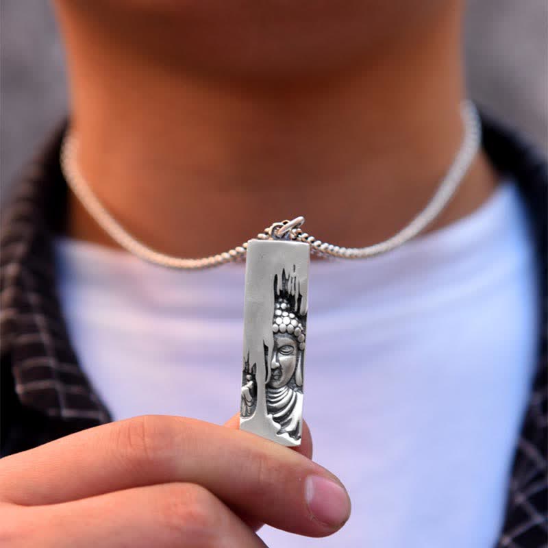 Tathagata Buddha Copper Amulet Necklace – hand holding rectangular Buddha pendant showing carved details, macro, art