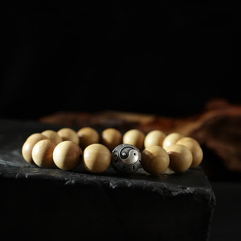 Peach Wood Cinnabar Bracelet – Side view yin yang guru bead on wooden prayer bracelet, balance