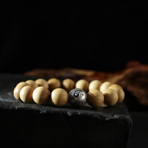 Peach Wood Cinnabar Bracelet – Side view yin yang guru bead on wooden prayer bracelet, balance