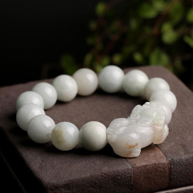 Jade PiXiu Bracelet – On textured stone with blurred greenery, nature background, feng shui wealth charm