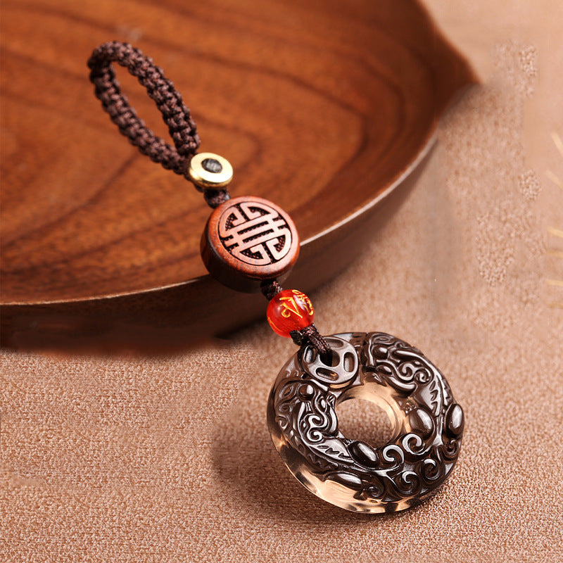 Pixiu Obsidian Keychain – obsidian pixiu disc on brown fabric with wooden tray, lucky car keychain