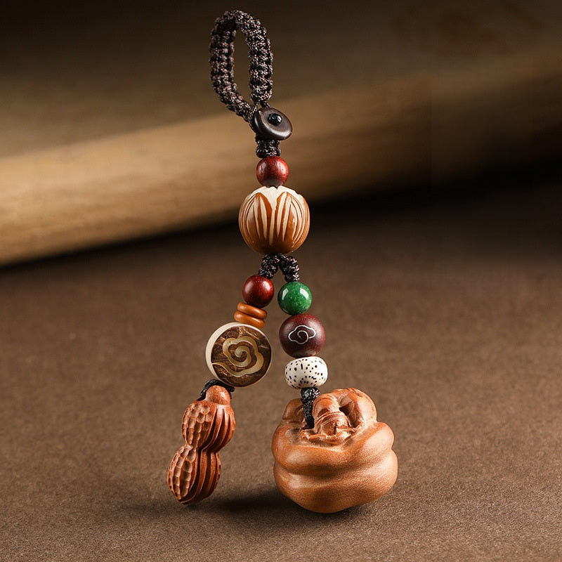 Peach wood Feng Shui keychain with braided cord, lotus bead and auspicious cloud medallion