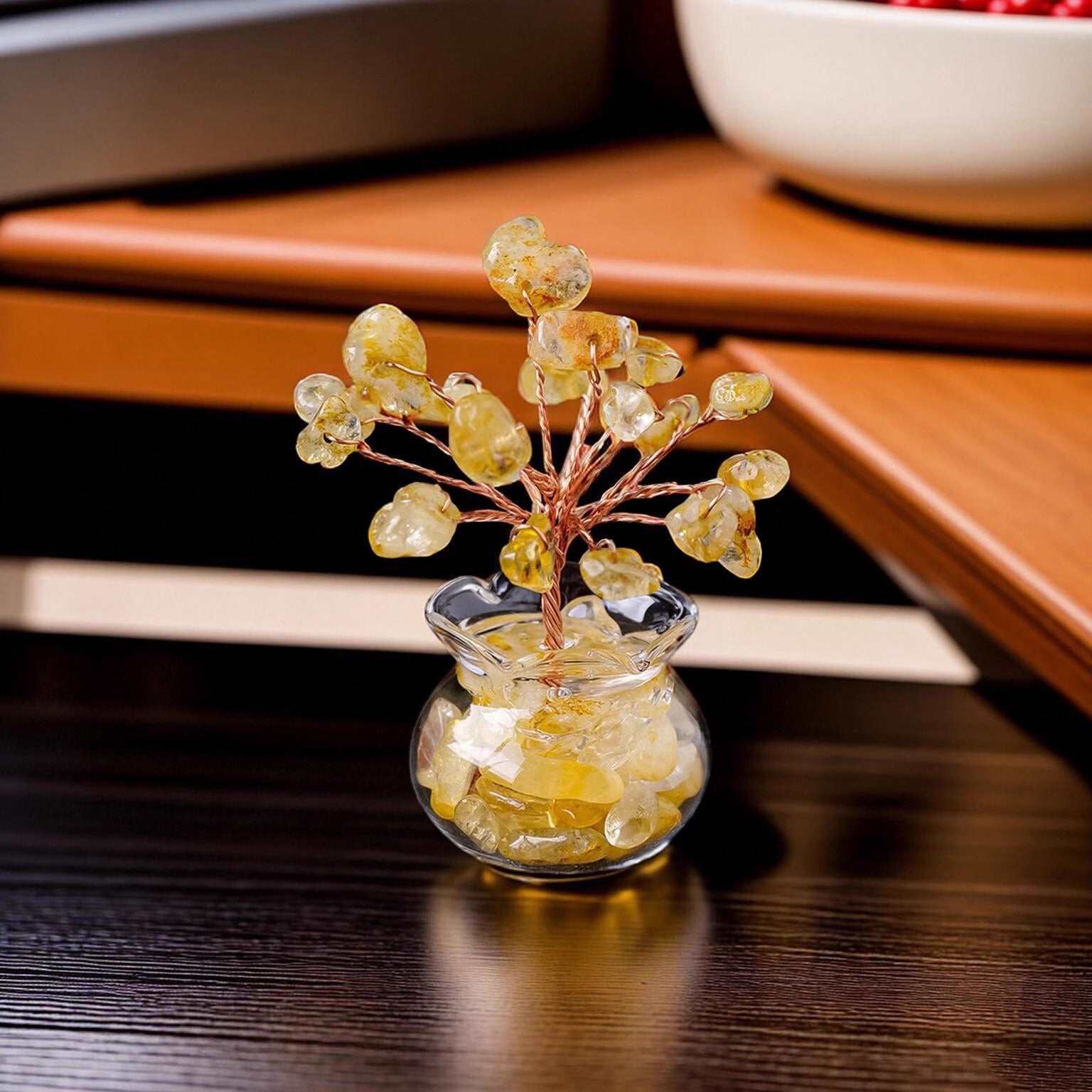 Mini Wealth Tree – citrine tree on dark wood desk, warm interior setting, glass geode pot, office prosperity decor