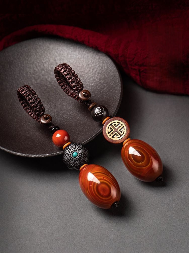Red Agate Car Keychain – two red agate keychains with different wood beads on black dish, couple feng shui set