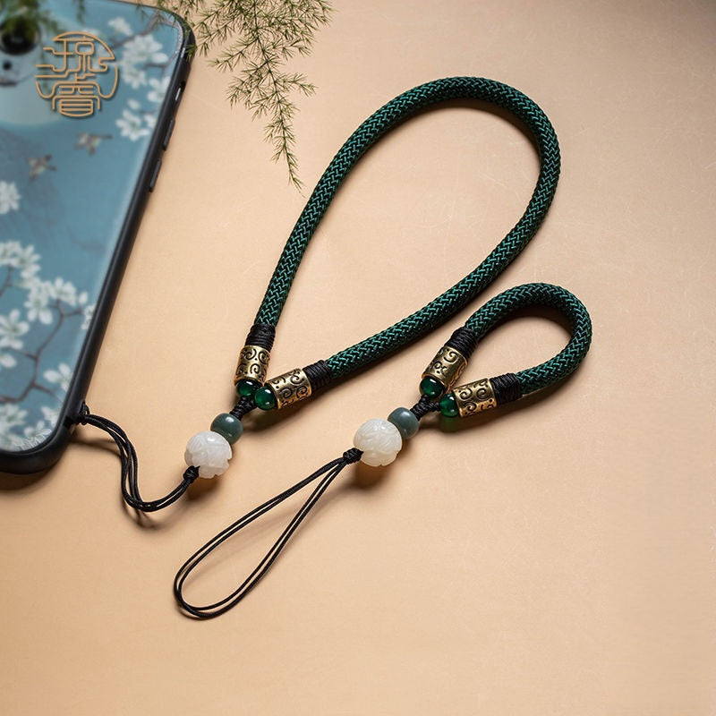 Lotus Bodhi Lanyard – Two green lanyards attached to floral blue phone case with cherry blossoms, paired Zen phone charms