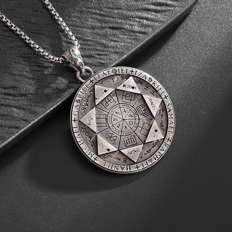 Seven Archangels Pendant – Close-up front seal on black textured surface, engraved angel names