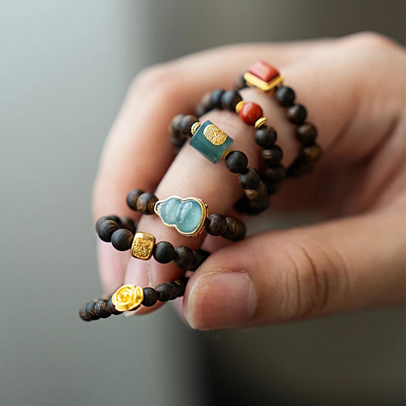 Agarwood Ring – multiple stacked rings with mixed jade and gold charms on fingers, variety showcase