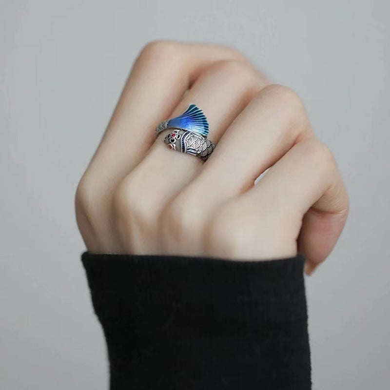 Enamel Carp Ring – silver fish ring with blue enamel tail displayed on finger in soft neutral light, success ring