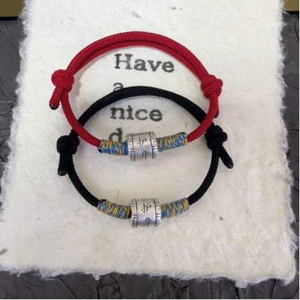 Red String Couple Bracelets – red and black pair on white fabric with silver blessing beads, protection jewelry Main image