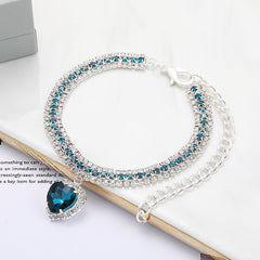 Crystal Rhinestone Pet Collar – Teal rhinestone band with sapphire heart pendant on white, bling pet necklace