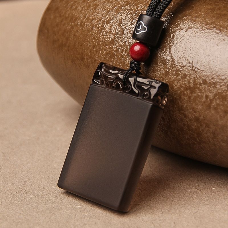 Black Obsidian Pendant – Glossy black obsidian guard plaque with carved top and red accent bead, healing crystal