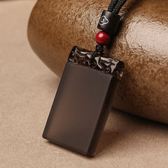 Black Obsidian Pendant – Glossy black obsidian guard plaque with carved top and red accent bead, healing crystal