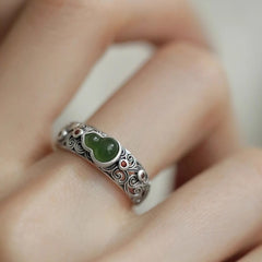 Jade Gourd Ring – green jade gourd set in carved silver band with auspicious cloud patterns, worn on finger close-up, health jewelry
