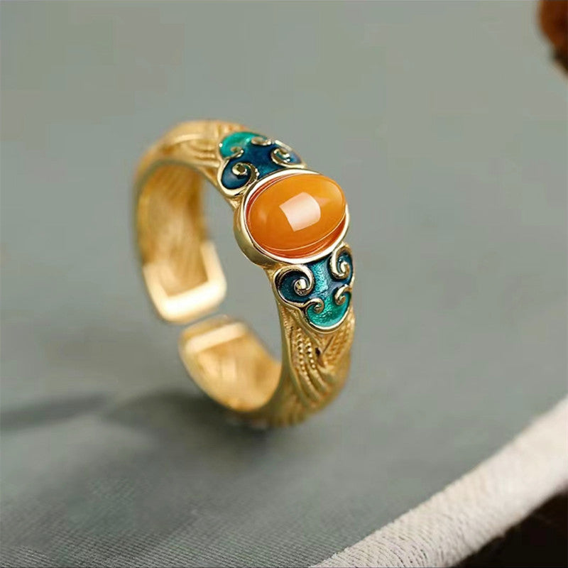 Amber Enamel Ring – gold open band with orange resin stone and blue cloud enamel on gray