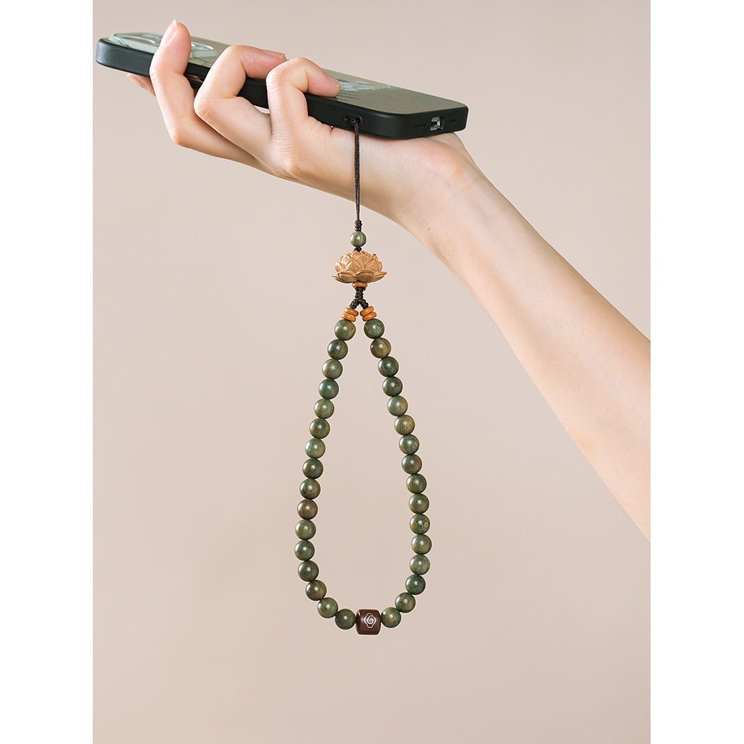 Zodiac Wood Bead Lanyard – Female hand gripping phone with green wood bead lotus strap hanging, usage scenario portrait