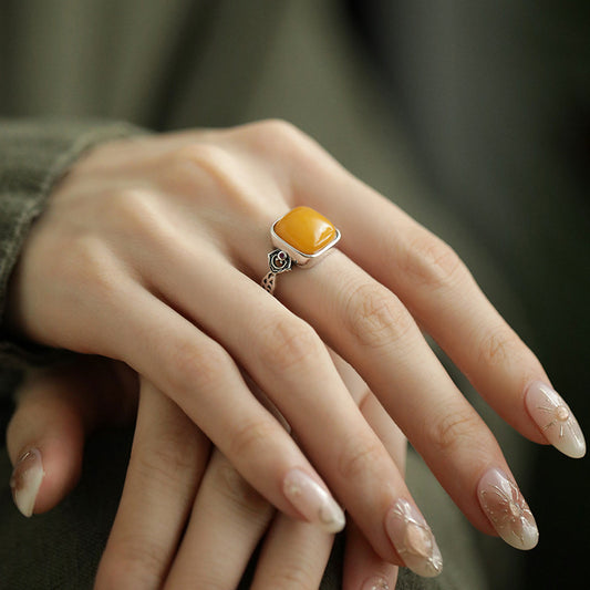 Honey Amber Sugar Cube Ring – Two hands showing silver ring with amber cube and engraved band, women jewelry
