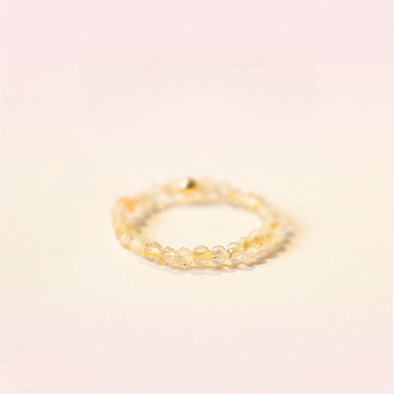 2mm Citrine Ring – Pale citrine tiny faceted beads on soft pink background, tiny gold stack ring
