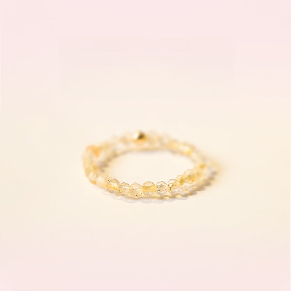 2mm Citrine Ring – Pale citrine tiny faceted beads on soft pink background, tiny gold stack ring