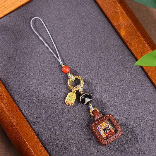 Tibetan Zakiram Thangka Amulet Keychain, angled view, lucky charm