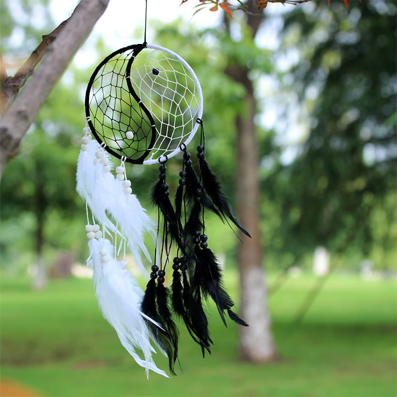 Yin Yang Dream Catcher with Feathers – Black white dreamcatcher in natural outdoor setting, boho decor