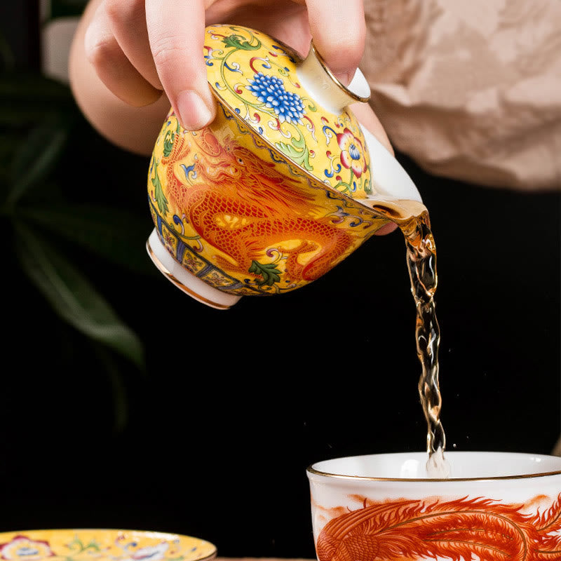 Dragon Phoenix Flower Gaiwan Tea Set – Yellow dragon gaiwan pouring amber tea into cup, ceremony action shot