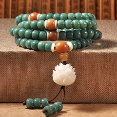 Lotus Cyan Bodhi Seed Bracelet - teal 108-bead mala with carved white lotus pendant and dual tassel, spiritual jewelry