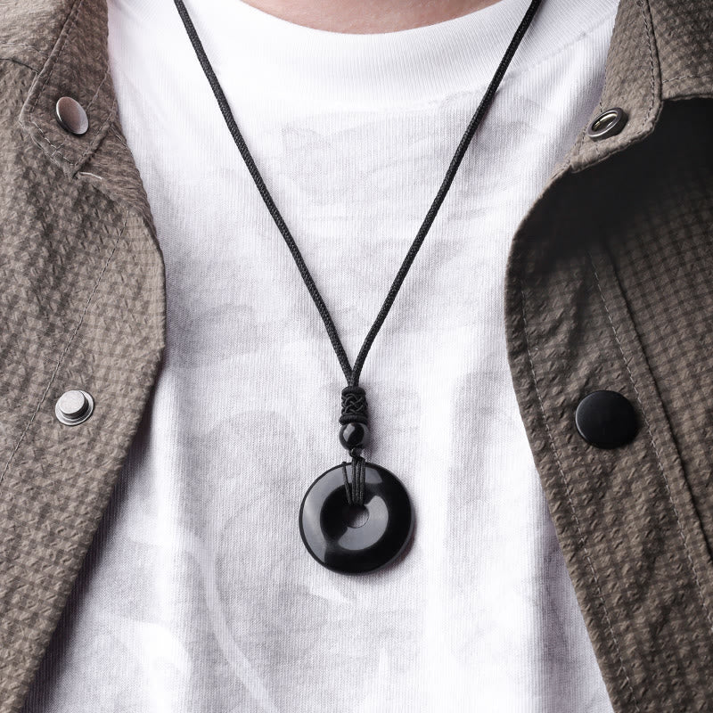 Lucky Coin Pendant Healing Crystal Gemstone Necklace – Black obsidian bi disc necklace worn over white shirt and olive jacket