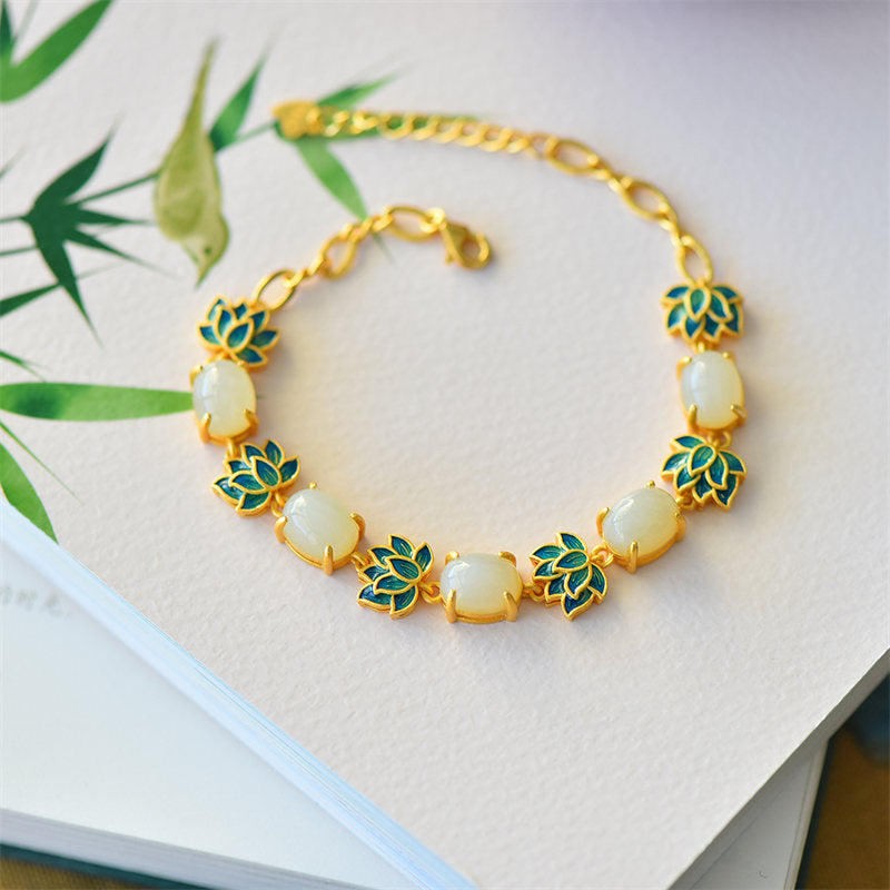 White Cyan Jade Lotus Bracelet - White jade cabochons with cyan enamel lotus, bamboo leaf, flat lay, protection