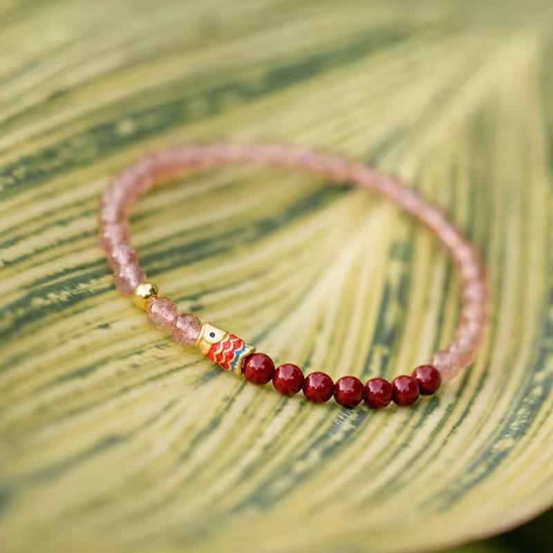 Strawberry Quartz Koi Bracelet – overhead flat lay on marble surface with natural stone aesthetic