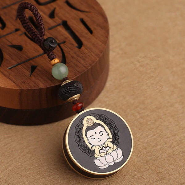 Ebony Avalokitesvara Keychain – held between fingers showing pocket-sized scale, everyday carry Buddha