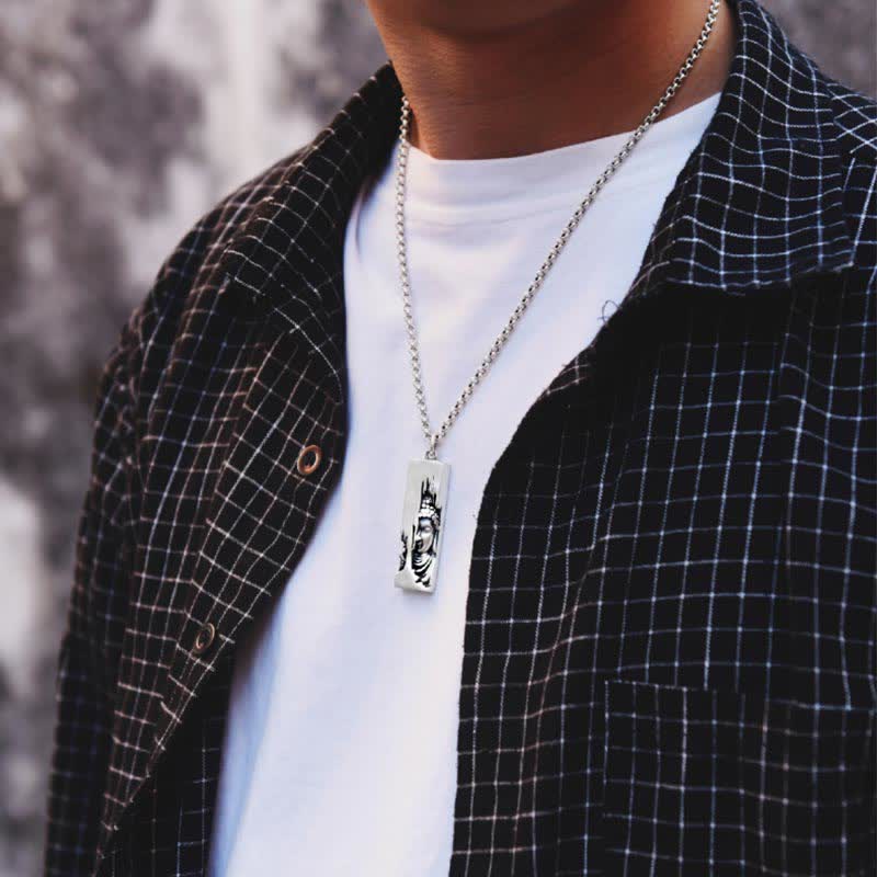 Tathagata Buddha Copper Amulet Necklace – closeup of man wearing Buddha pendant with silver chain outdoors, model-wear