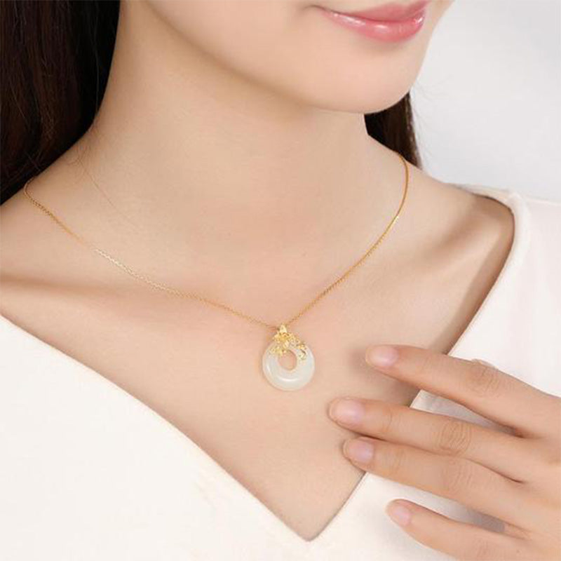 Tibetan White Jade Calm Necklace - model neck with hand at collarbone, jade pendant jewelry