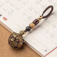 Pixiu Wealth Copper Key Chain – on calligraphy paper diagonal view, detailed brass pixiu patterns craftsmanship