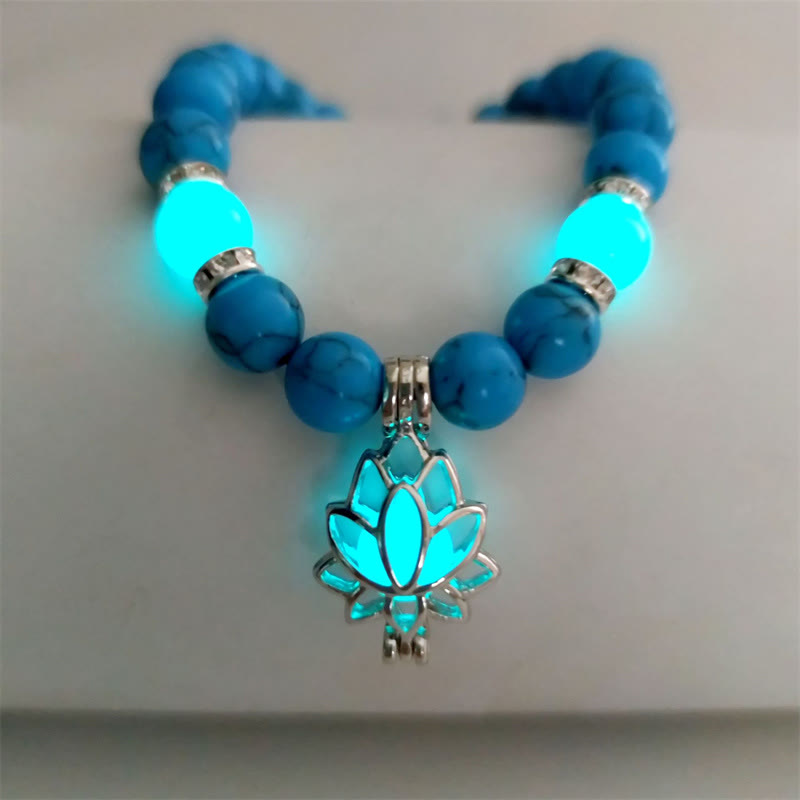 Tibetan Turquoise Glowstone Lotus Bracelet – turquoise beads with glowing lotus charm U-shape on neutral surface, glowstone