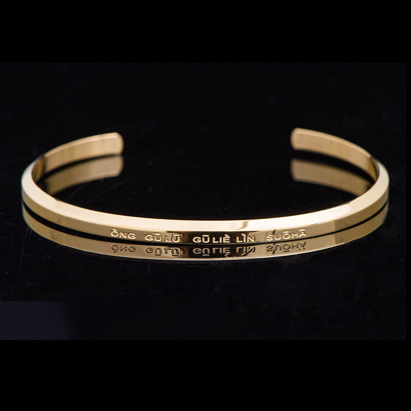 Om Mani Padme Hum Engraved Bracelet – gold cuff at three-quarter angle showing engraving, blessing bracelet