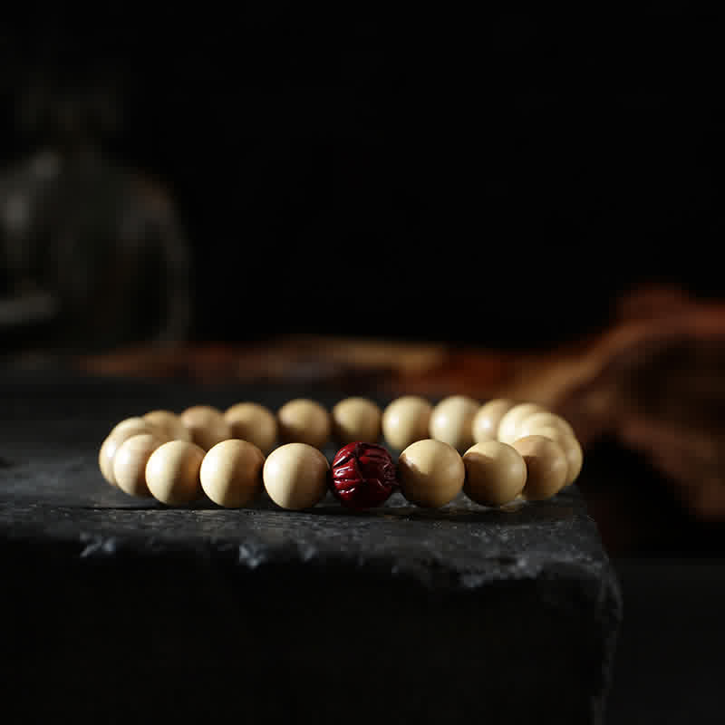Peach Wood Yin Yang Bracelet – Red cinnabar carved lotus bead on pale wood mala, protection bracelet