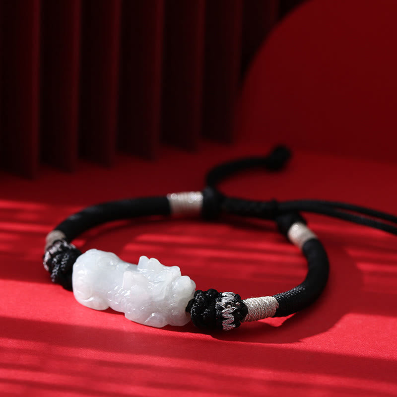 Natural Jade PiXiu Bracelet – flat lay on red surface with shadow, black adjustable cord, jade prosperity