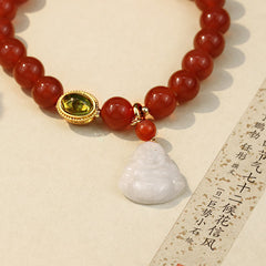 Red Agate Buddha Bracelet - Close-up of Buddha charm and green gemstone setting