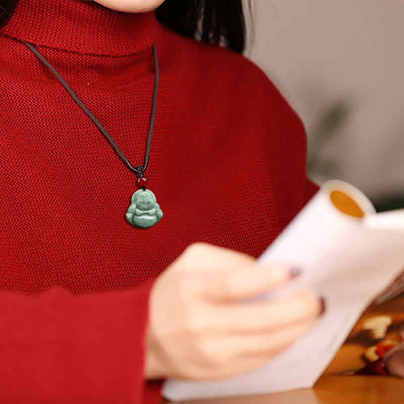 Green Jade Buddha Necklace Worn - jade laughing Buddha pendant on black cord against red sweater, lifestyle, Serene