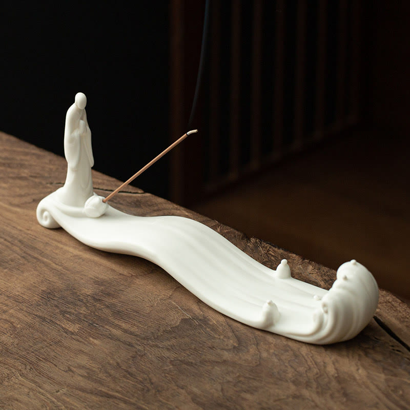 Buddha Monk Sea Wave Mountain Ceramic Incense Burner – White monk figure on flowing wave base with burning incense smoke, ceramic incense burner