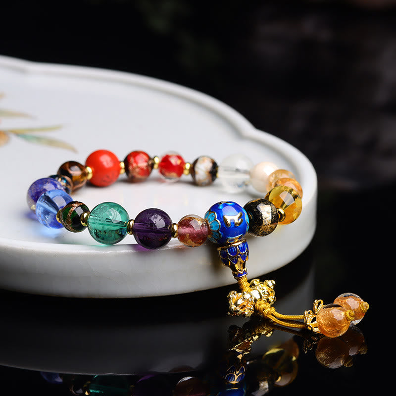 Tibetan Liuli Wrist Mala – Beaded bracelet in ceramic dish with black reflection and lotus cloisonne bead