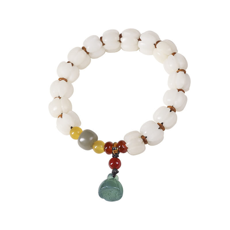 Bodhi Seed Lotus Bead Bracelet - top-down view, lotus beads with sage green charm